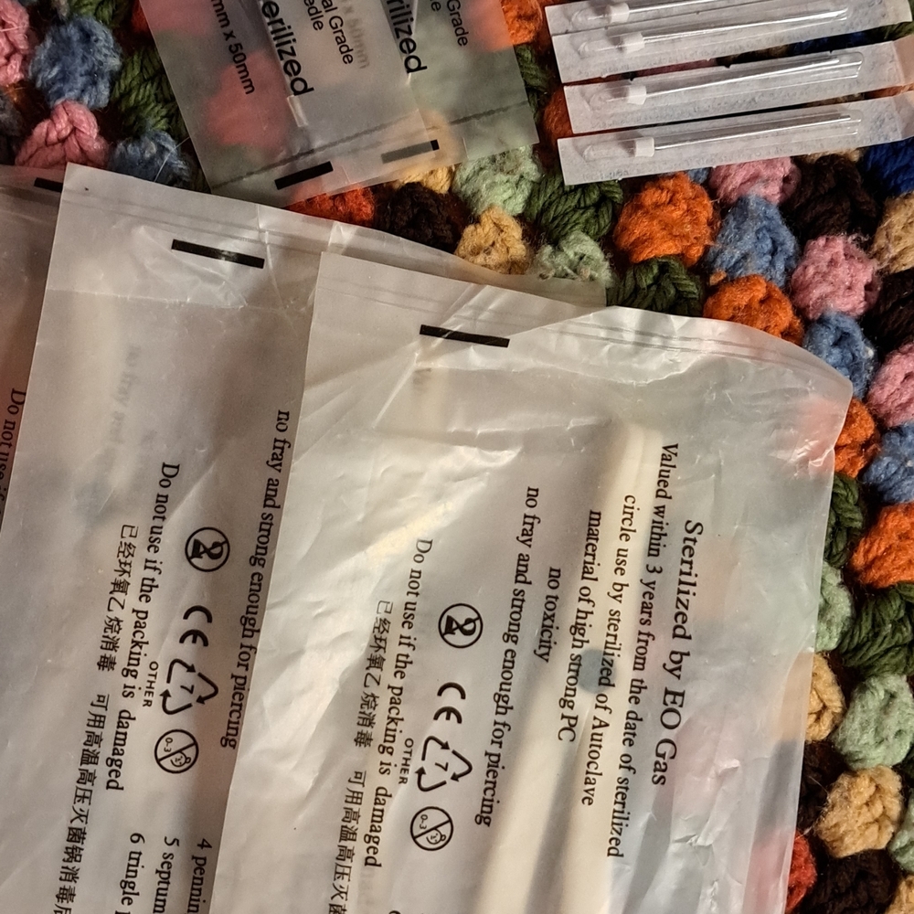 Assorted Piercing Needles, Clamps, Nose Or Eyebrow Rings.